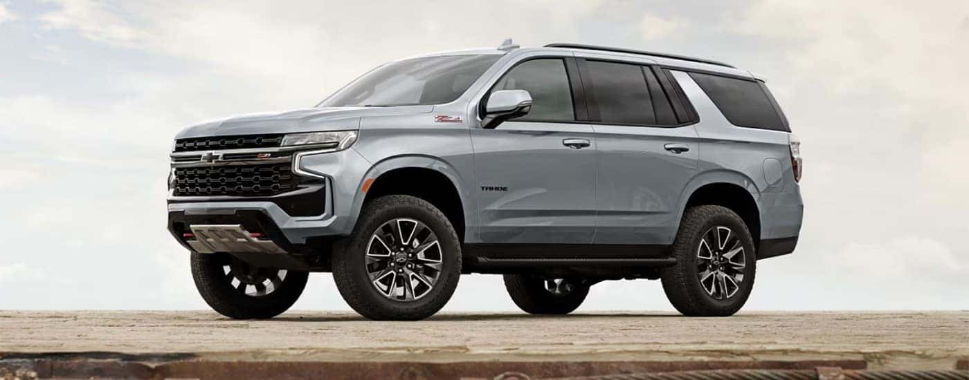 A popular Chevy Tahoe for sale, a silver 2024 Chevy Tahoe Z71, is shown parked on a platform.