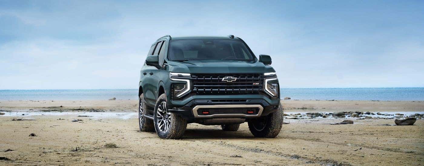 A green 2025 Chevy Tahoe Z71 parked off-road.