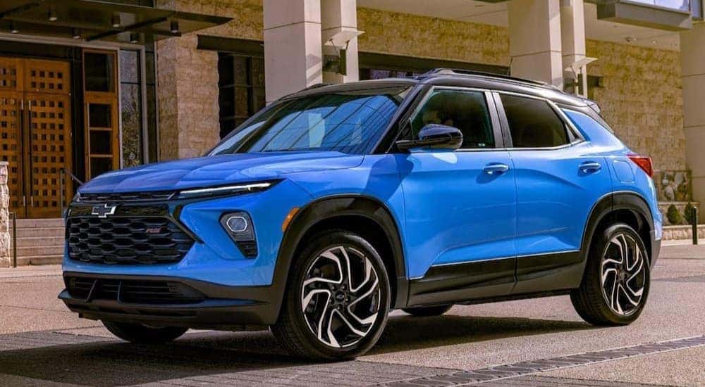 A blue 2026 Chevy Trailblazer RS parked near a building.