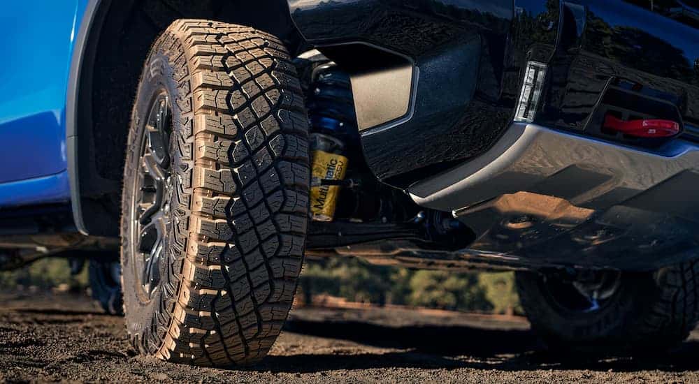 Rim and tire on a blue 2025 Chevy Silverado 1500