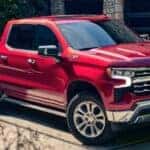 A red 2025 Chevy Silverado 1500 Z71 parked in a driveway.