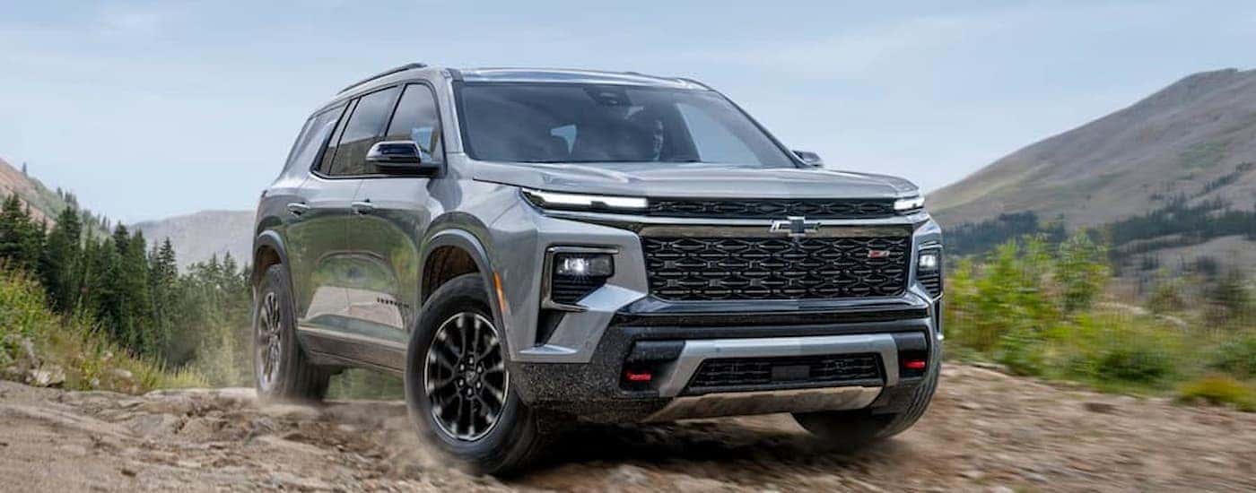 A gray 2025 Chevy Traverse driving off-road