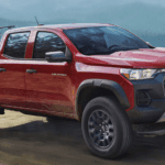 Red 2026 Chevy Colorado Trail Boss on a dirt trail
