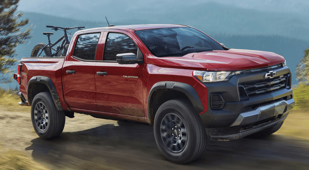Red 2026 Chevy Colorado Trail Boss on a dirt trail