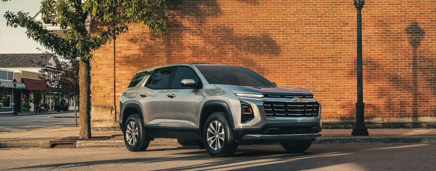 Grey 2026 Chevy Equinox parked near a brick wall.