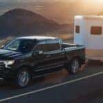 Black 2026 Chevy Silverado 1500 towing a trailor