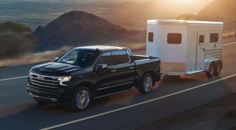 Black 2026 Chevy Silverado 1500 towing a trailer