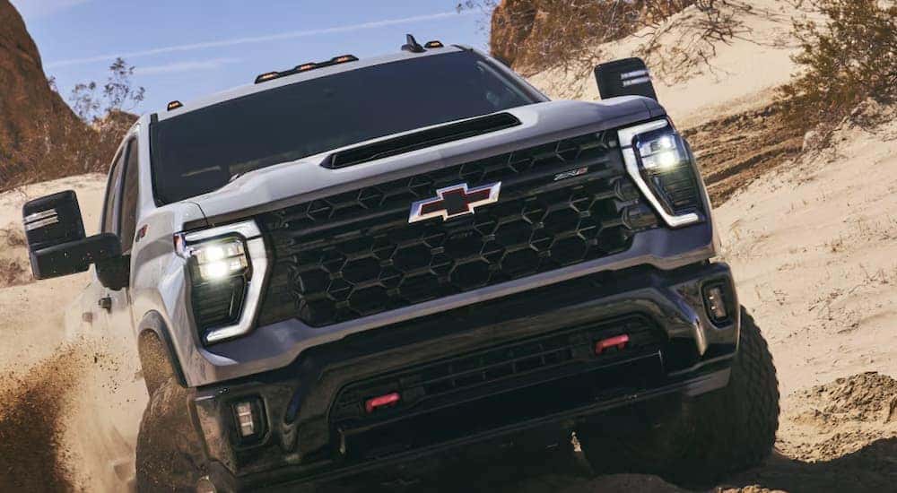 A gray 2026 Chevy Silverado 2500 HD off-roading in sand