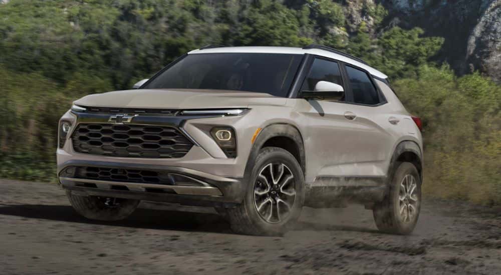 Tan 2026 Chevy Trailblazer driving through the woods.