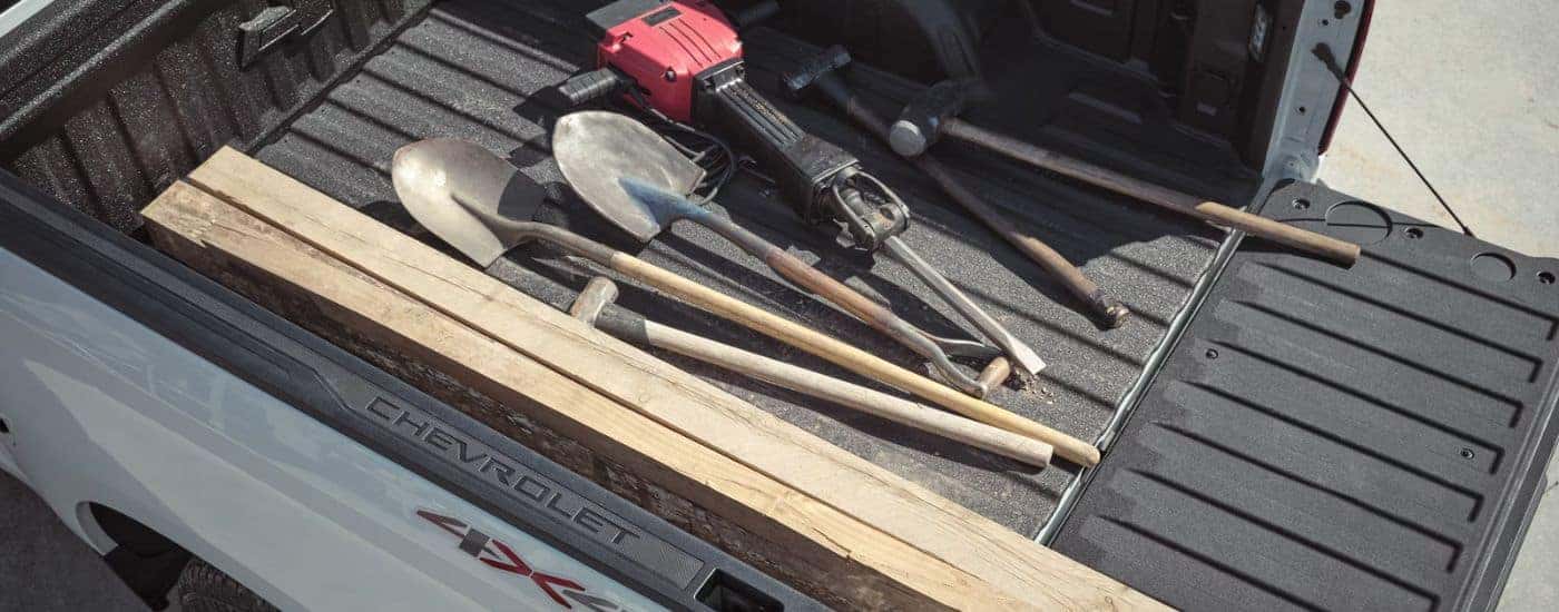 Tools in the bed of a White 2026 Chevy Silverado 1500.