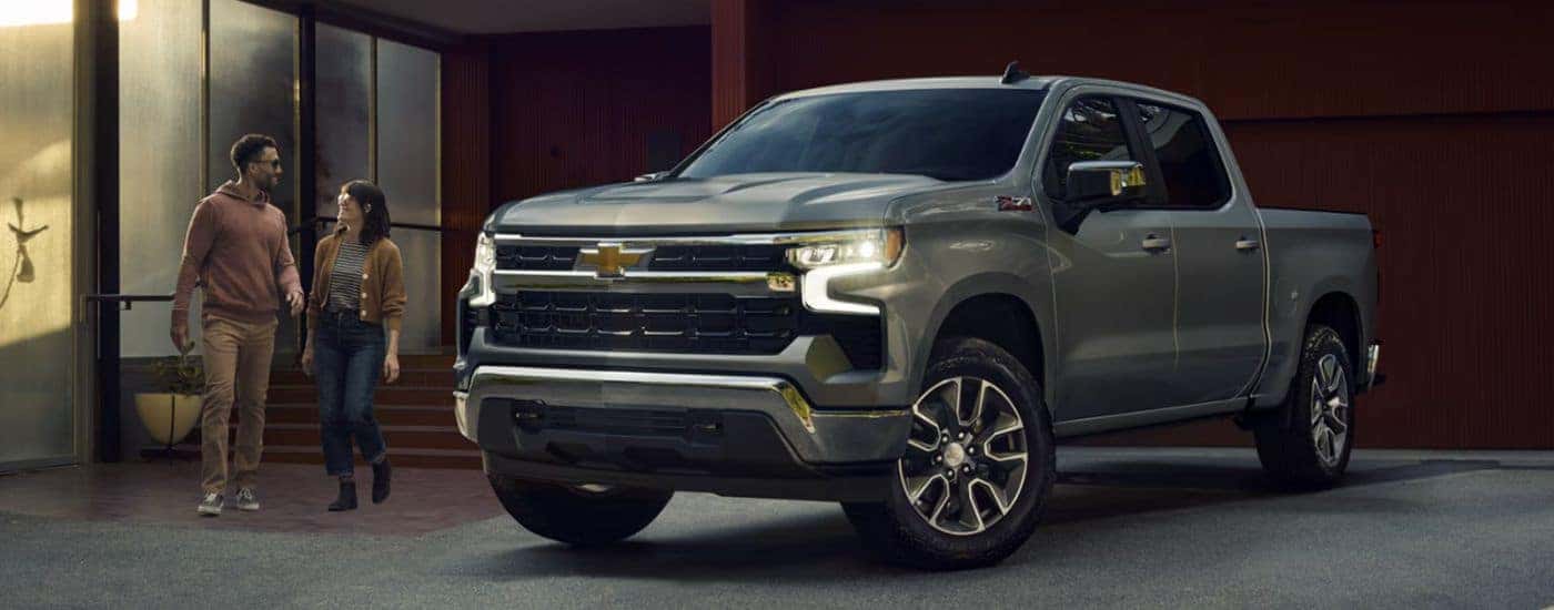 A gray 2026 Chevy Silverado 1500 LT is shown parked in a driveway.