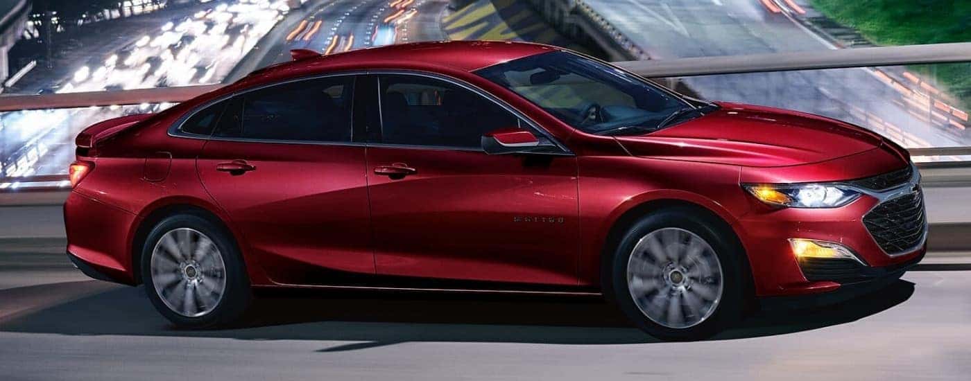 A red 2023 Chevy Malibu crossing a bridge.