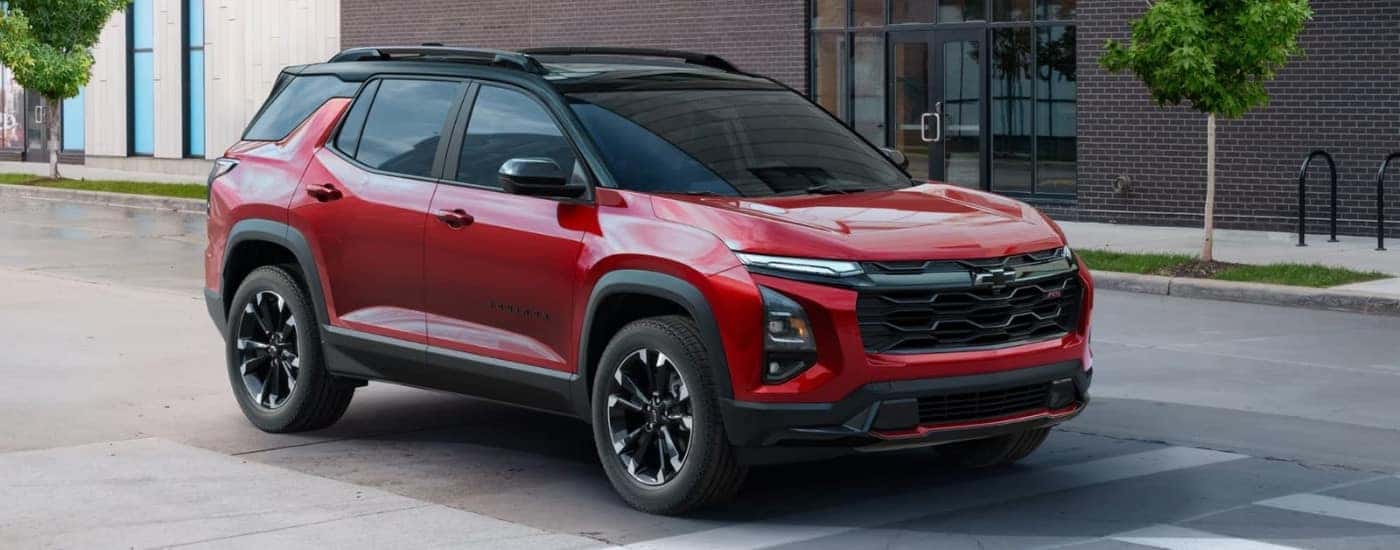 A red 2025 Chevy Equinox RS driving over a crosswalk,