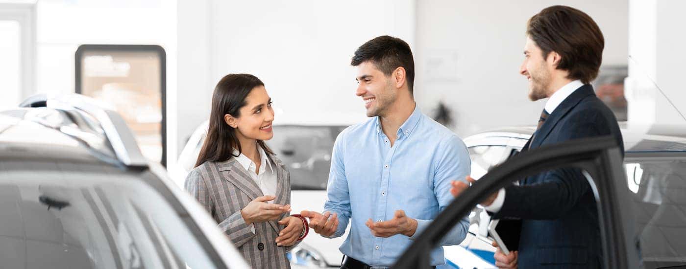 A salesman and couple discussing financing.