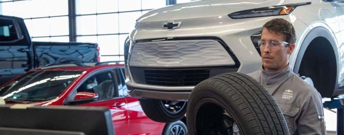 A tech working on a 2023 Chevy Bolt EV tire installation.