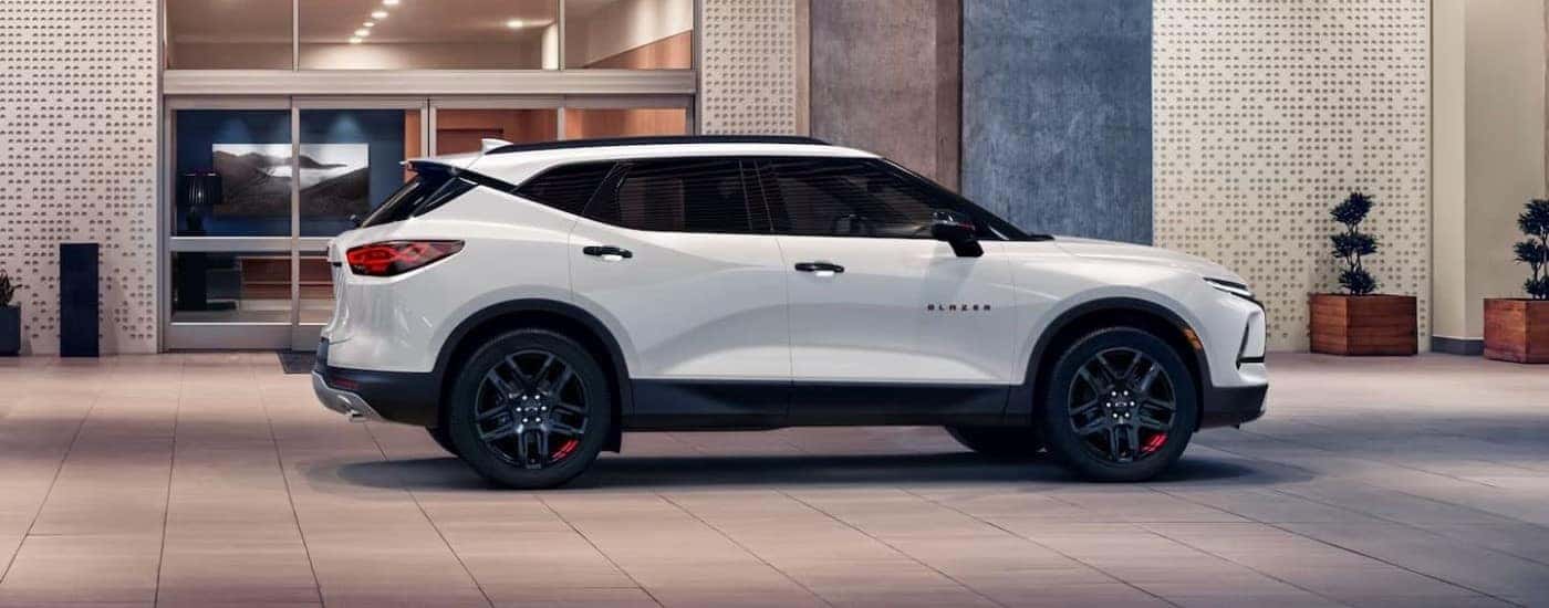 A white 2023 Chevy Blazer Redline parked by a building.