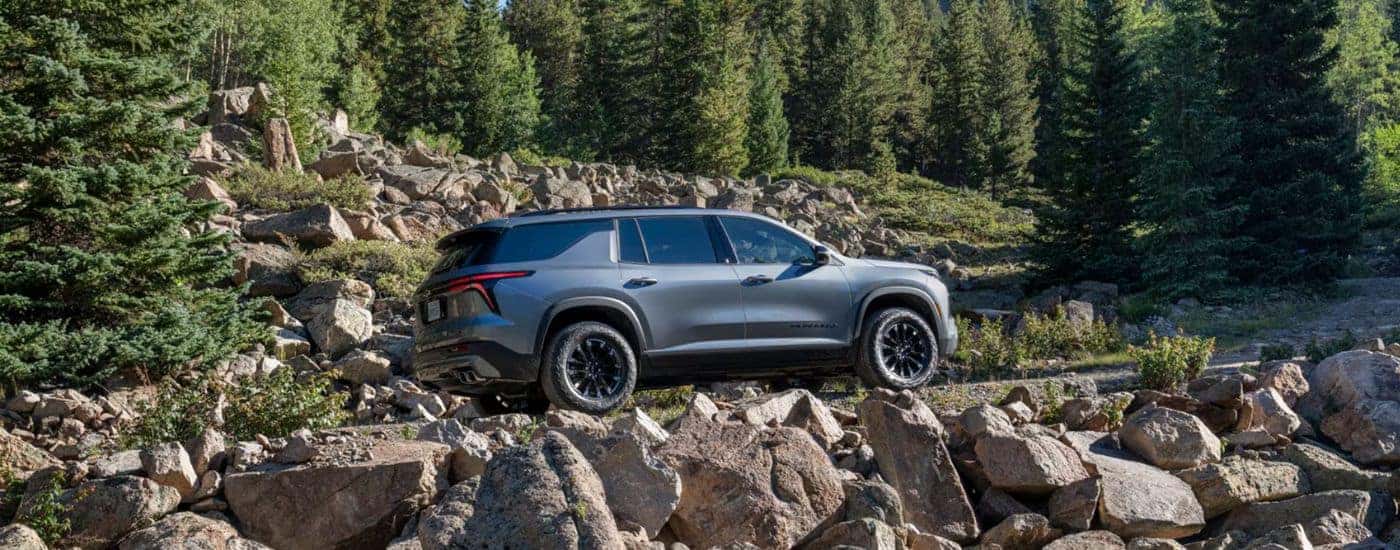 A gray 2026 Chevy Traverse Z71 driving a rocky dirt road.
