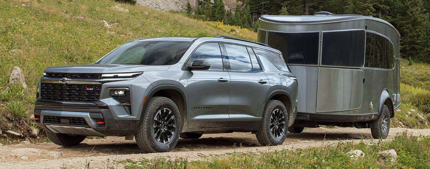A gray 2026 Chevy Traverse Z71 towing a trailer.