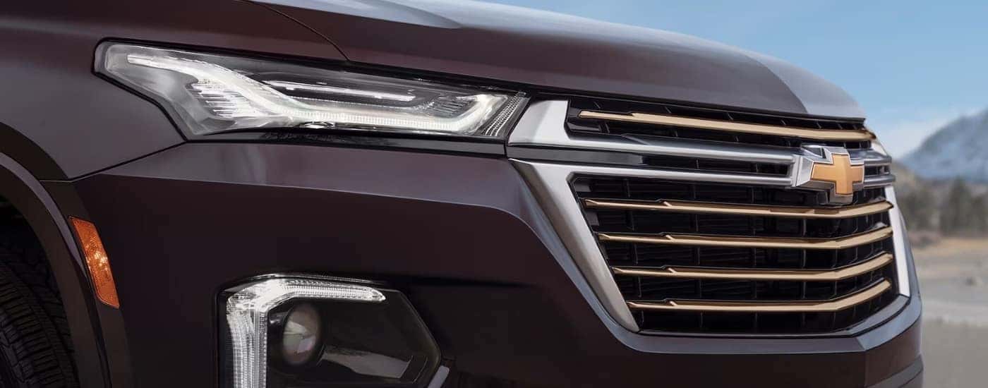 Front grille of a maroon 2022 Chevy Traverse.