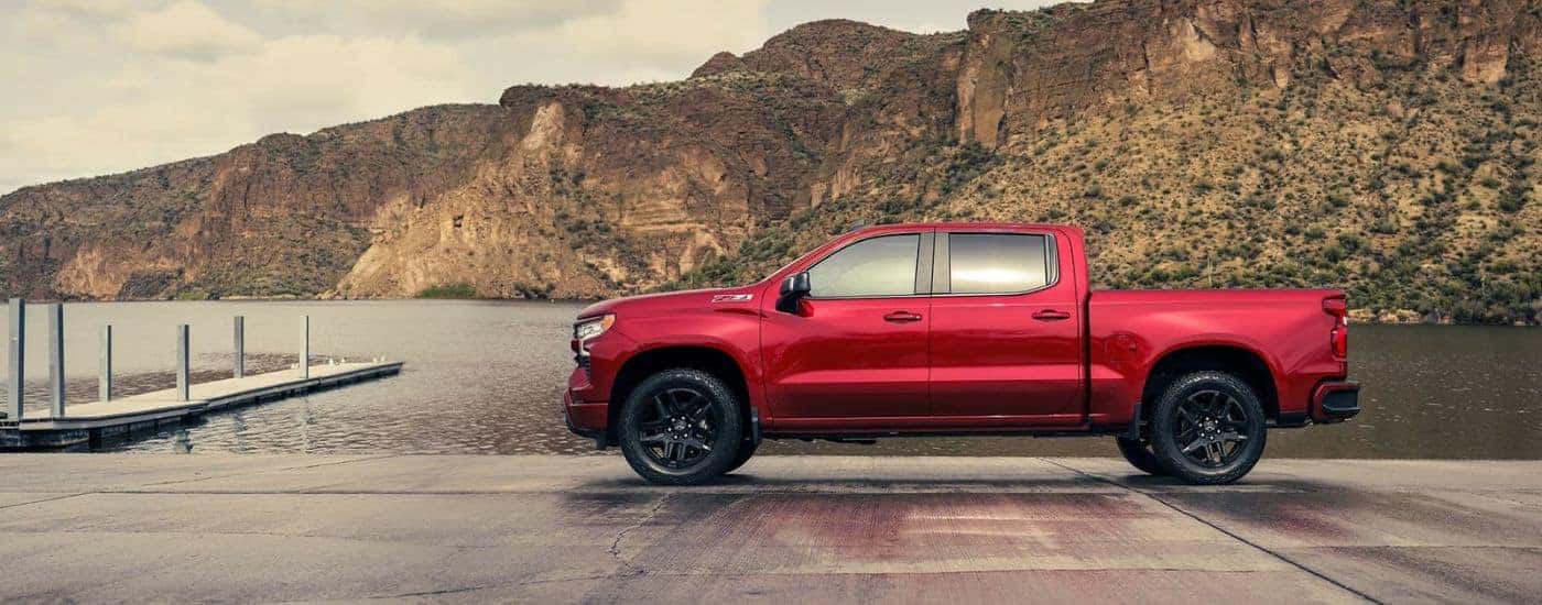 A red 2023 Chevy Silverado 1500 RST Z71 parked on a dock.