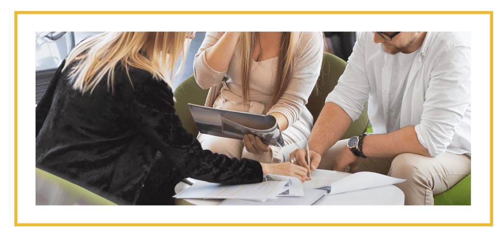 Things to Bring with you to Purchase a Car at CMA Chevrolet of Martinsburg in Martinsburg, WV | Couple signing paper work for car while the sales person in black showing them where to sign 