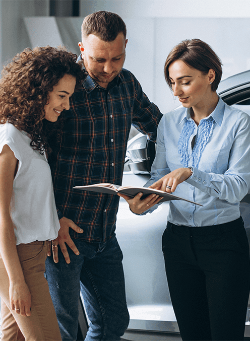 Leasing versus Buying a Chevrolet at CMA Chevrolet of Martinsburg in Martinsburg, WV | Sales person showing a couple, the documents for leasing a car