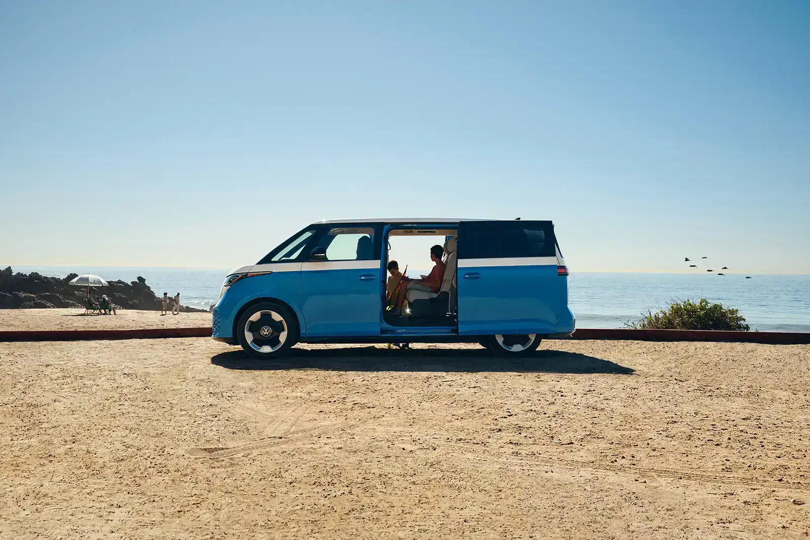 2027 Volkswagen ID.Buzz profile view on a beach - available at Emich Volkswagen of Boulder in Boulder, CO