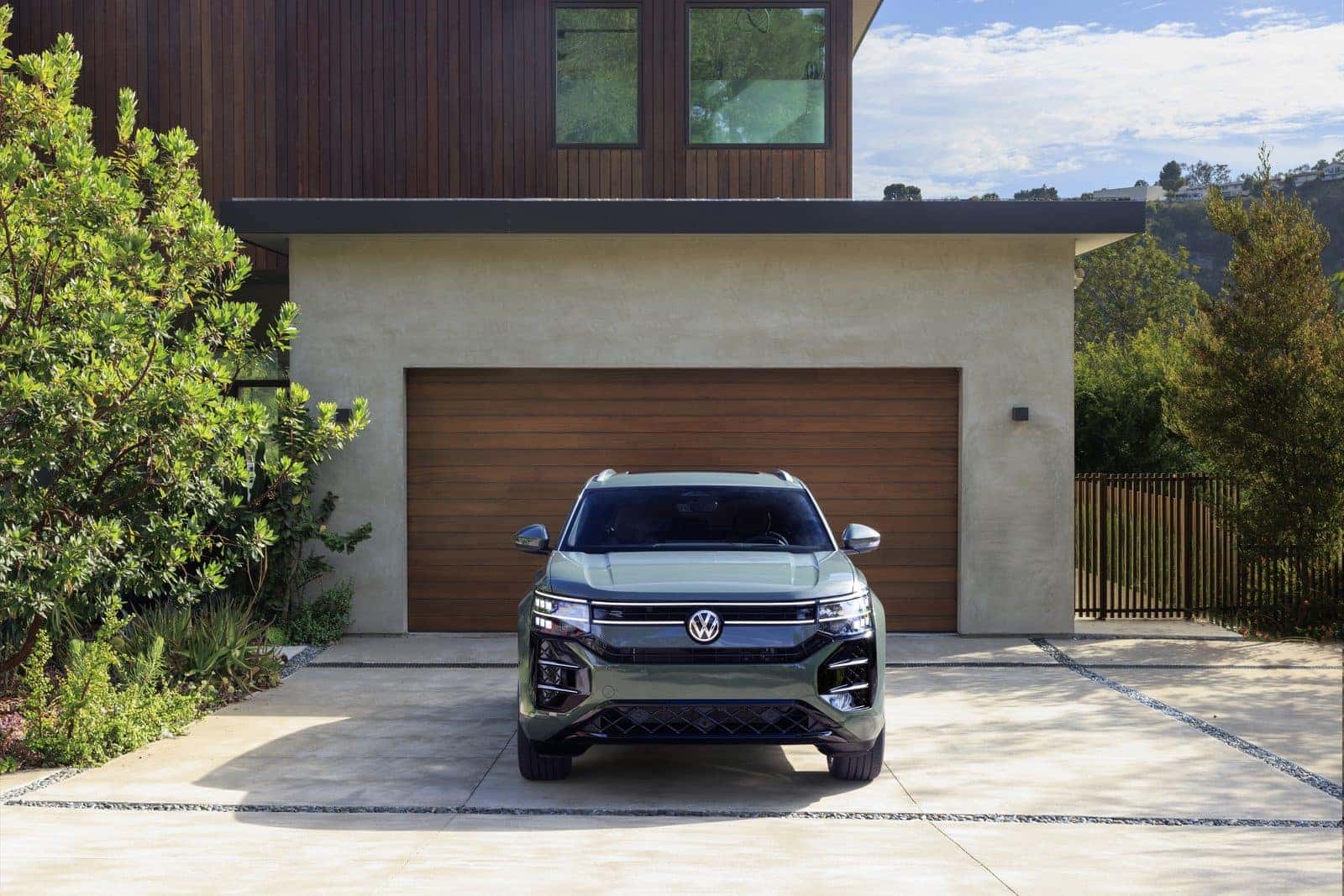 Front view of the 2027 Volkswagen Atlas Cross Sport with double-stacked LED headlights and illuminated VW badge