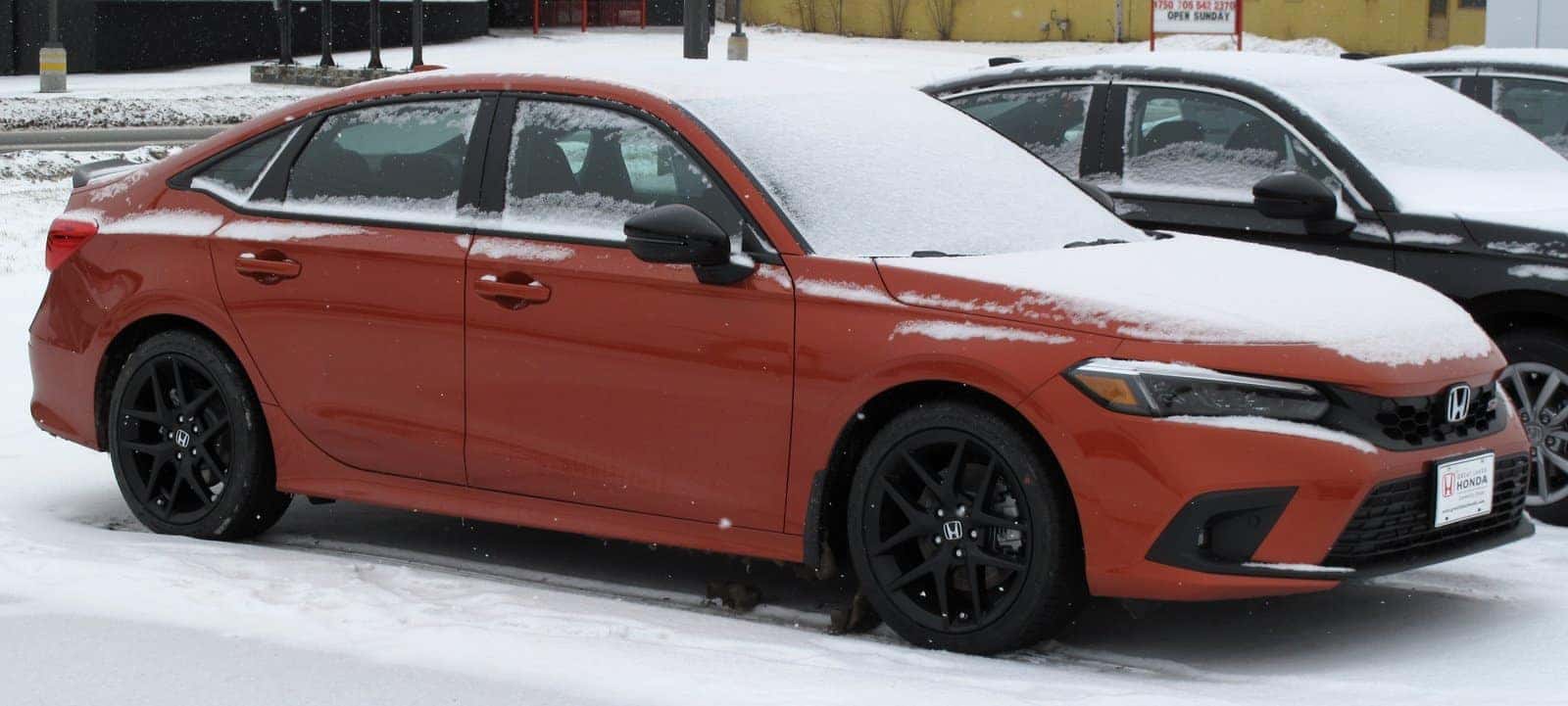 Honda Civic Si in Blazing Orange, front three-quarter view
