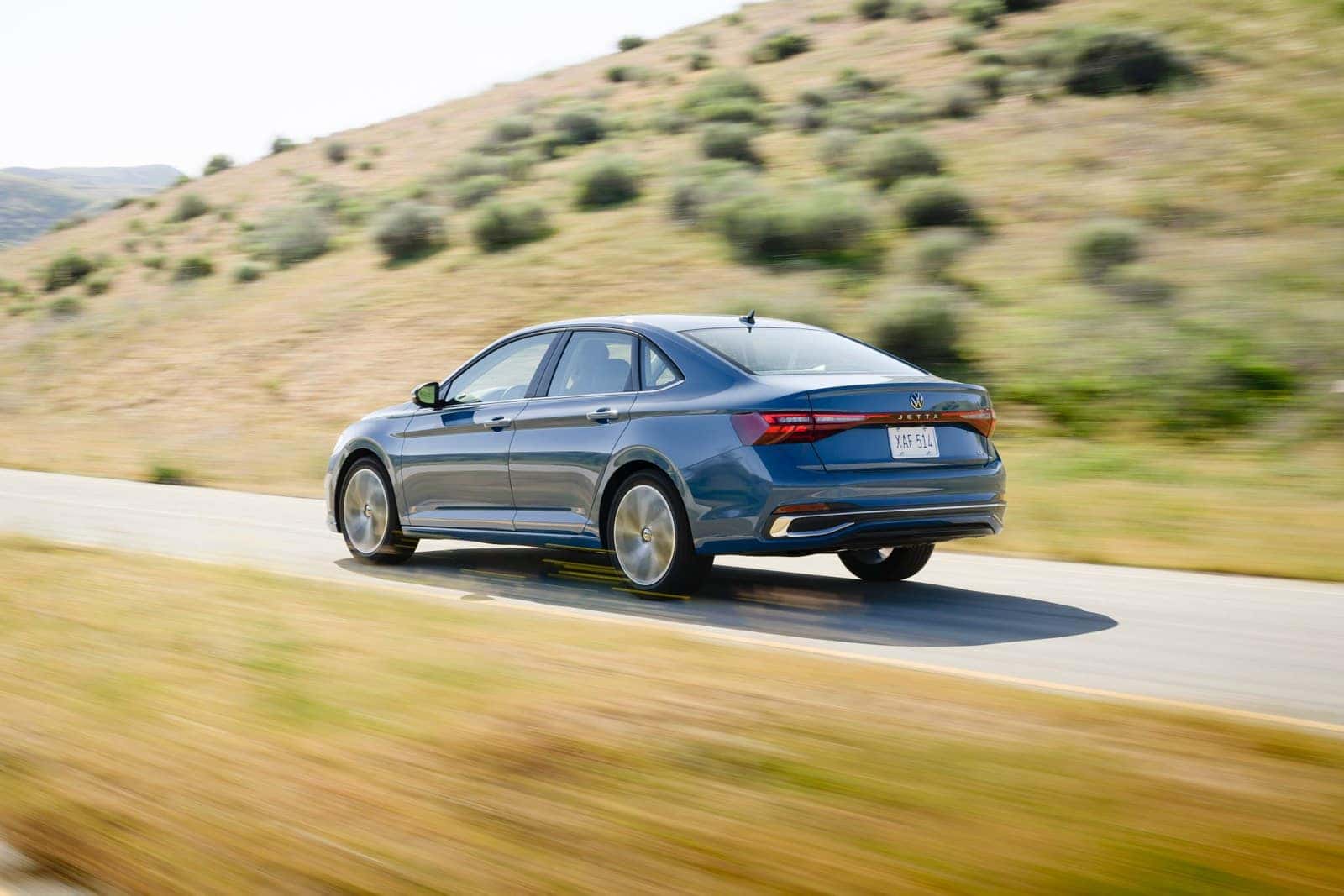 Volkswagen Jetta in Monterey Blue Pearl on a mountain highway