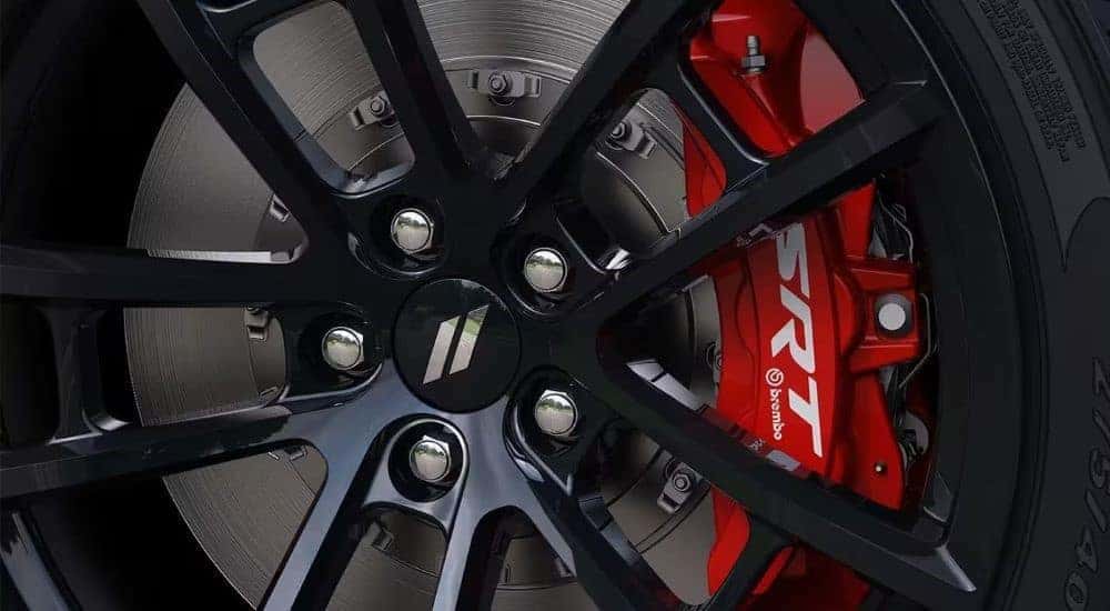 A close-up of a wheel on a 2023 Dodge Challenger SRT is shown.