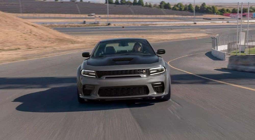 A gray 2023 Dodge Charger Scat Pack is shown driving on a track after visiting a Dodge dealer near Rock Hill.