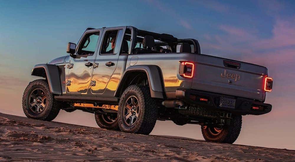 A gray 2024 Jeep Gladiator Mojave is shown parked off-road.