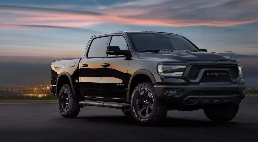 A black 2024 Ram 1500 Rebel parked and angled right.