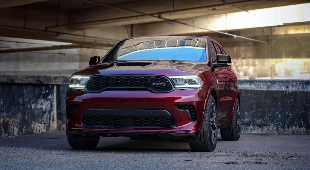 A red 2024 Dodge Durango SRT parked in a concrete garage.