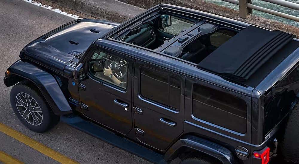 A grey 2025 Jeep Wrangler is shown from a high angle with the top open.