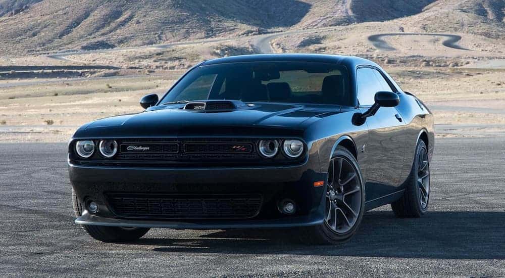 A black 2021 Dodge Challenger RT Scat Pack is shown parked on pavement.