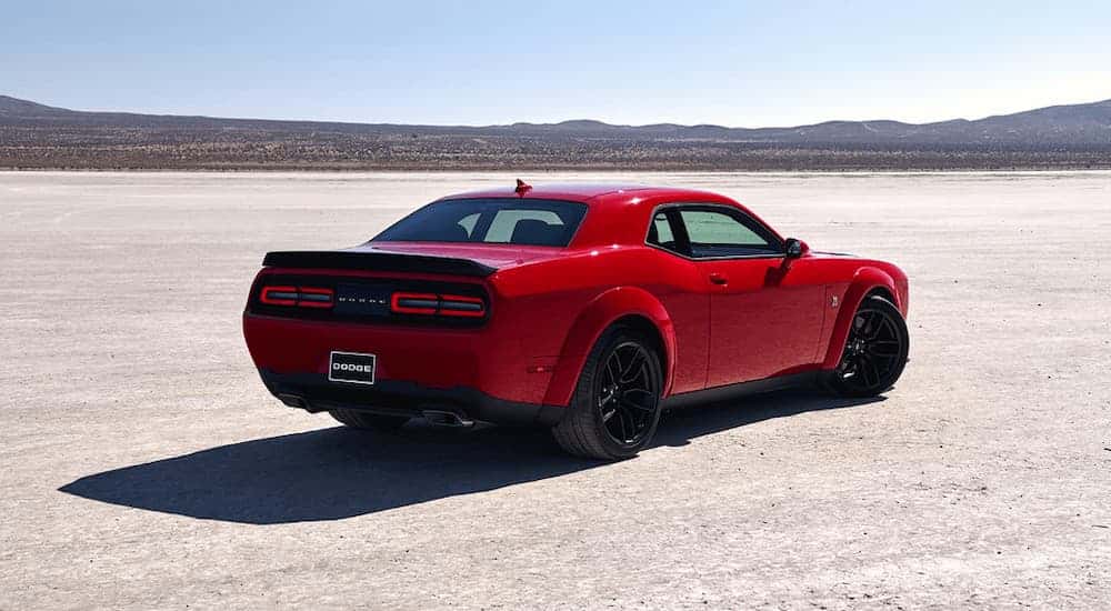 A red 2021 Dodge Challenger for sale is shown parked on a sunny day.