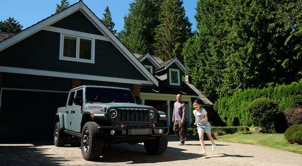 A green 2024 Jeep Gladiator Rubicon X parked on a driveway.