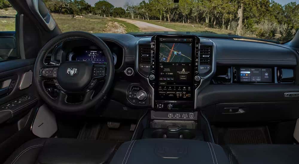 The black interior and dash is shown in a 2025 Ram 1500.