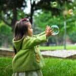 photo of girl holding bubbles