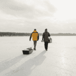 Two people pulling a sled walking in the winter