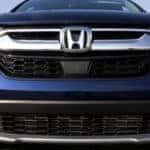 Up close photo of the front of a navy Honda SUV