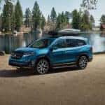 Blue 2022 Honda Pilot parked in a scenic area by a lake