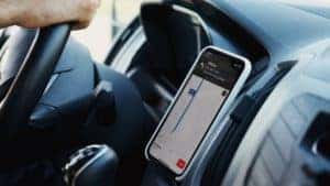 A stationed phone being used for navigation with the map app on the screen