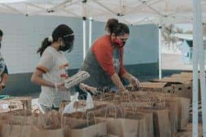 Two people volunteering at a local food bank