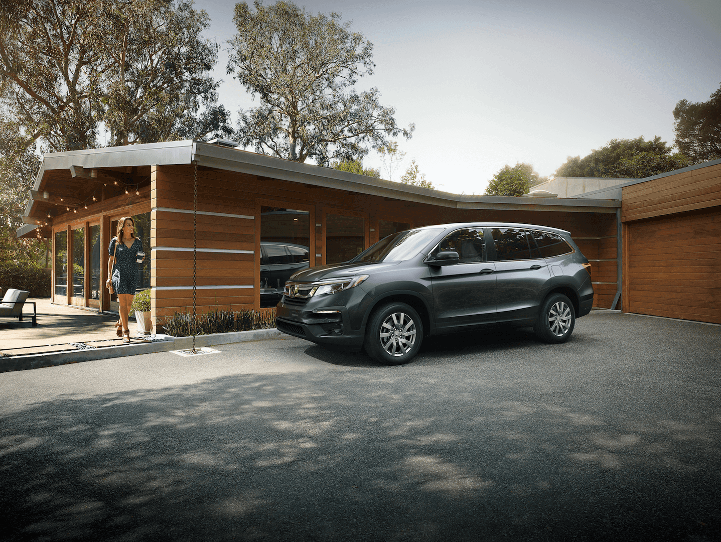 Woman walking to her Honda Pilot