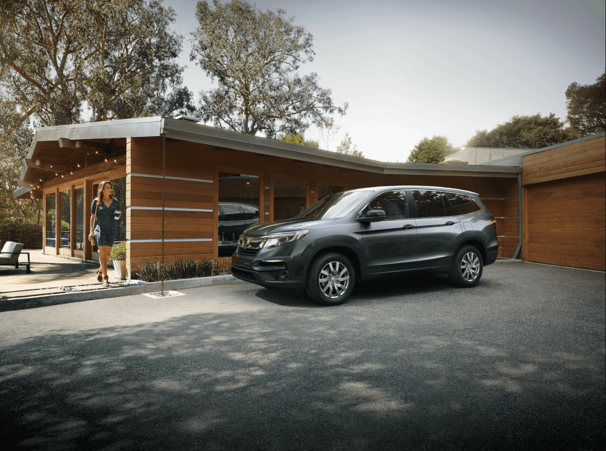 Woman walking to her Honda Pilot