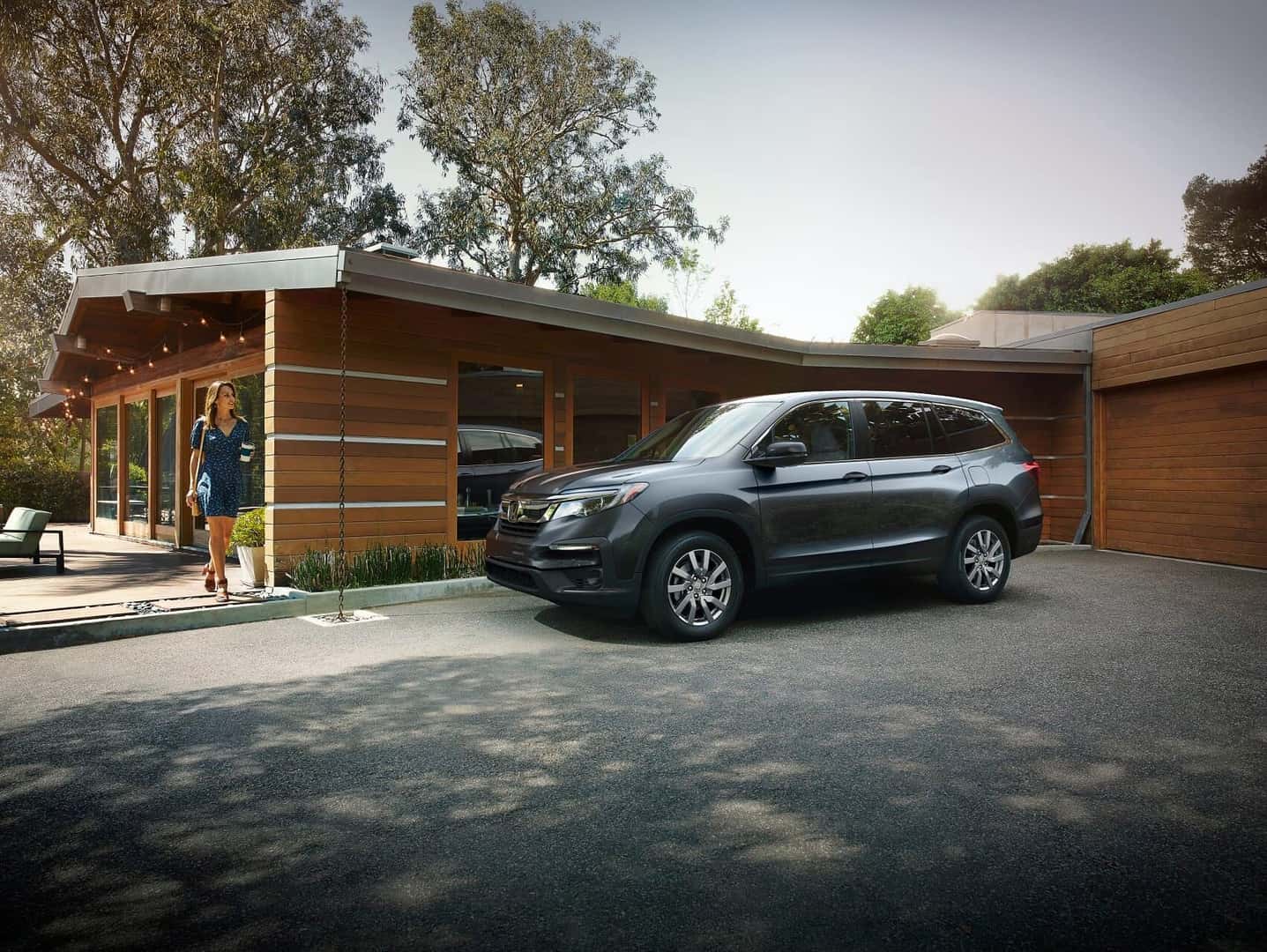 Woman walking to her Honda Pilot