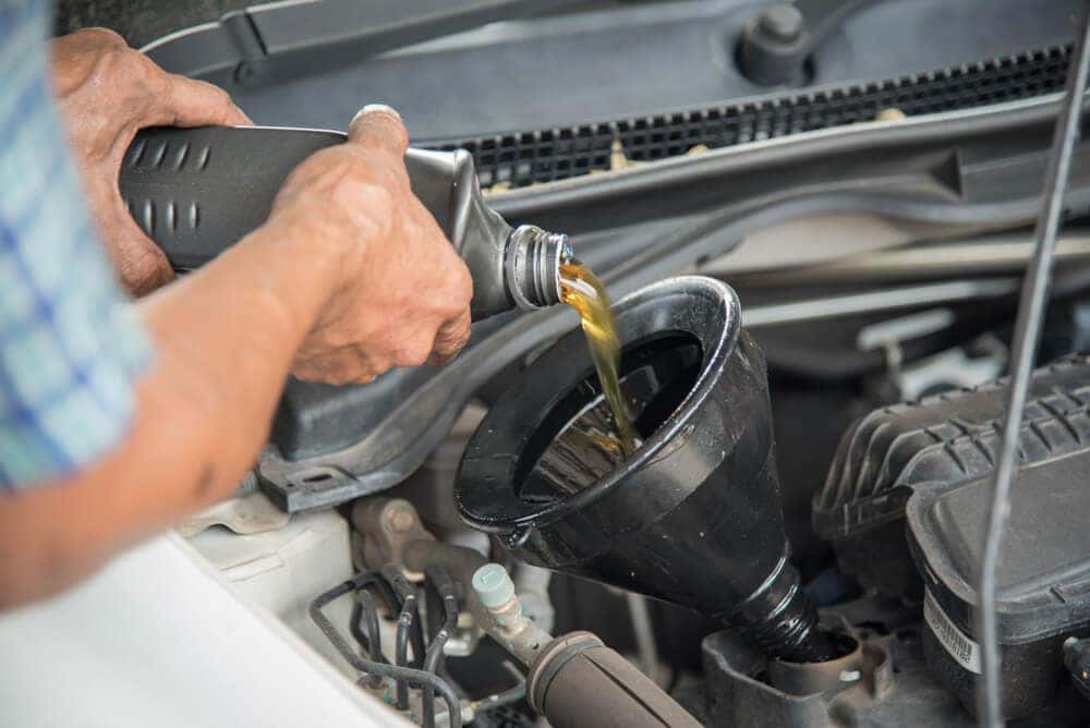 Mechanic Pouring Oil